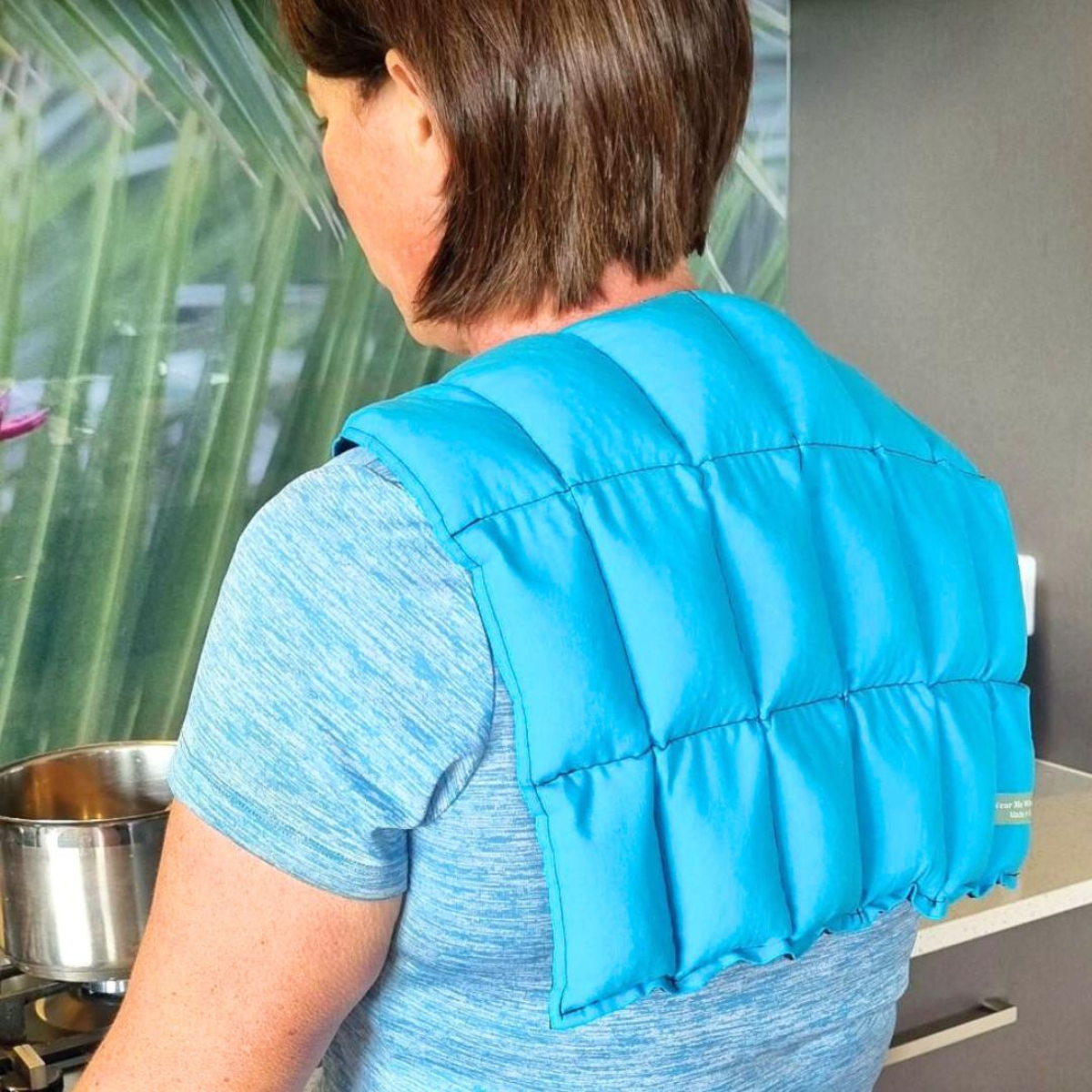 Turquoise over shoulder wheat bag, back view