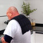 Man wearing Over Shoulder wheat bag while cooking